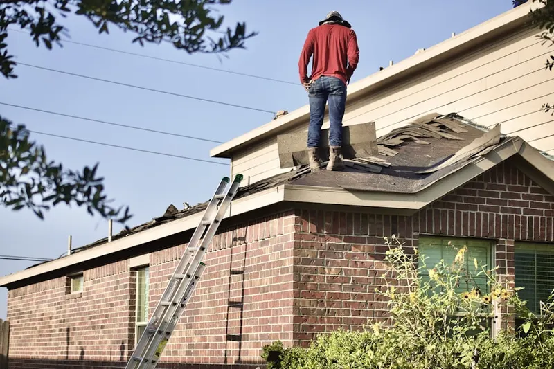 Professional roofer working on a residential roof in Chinatown